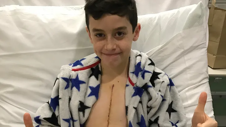 Fin giving a thumbs up in hospital after heart surgery